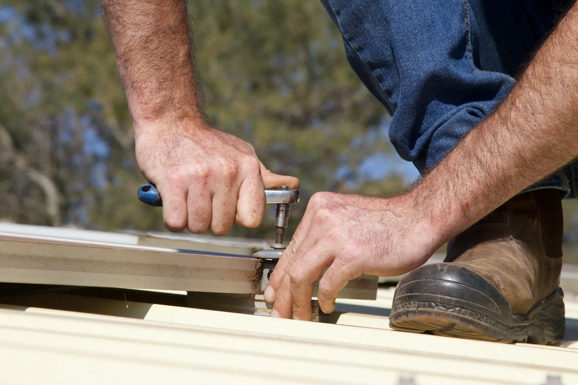 Hands tightening a bolt with a wrench